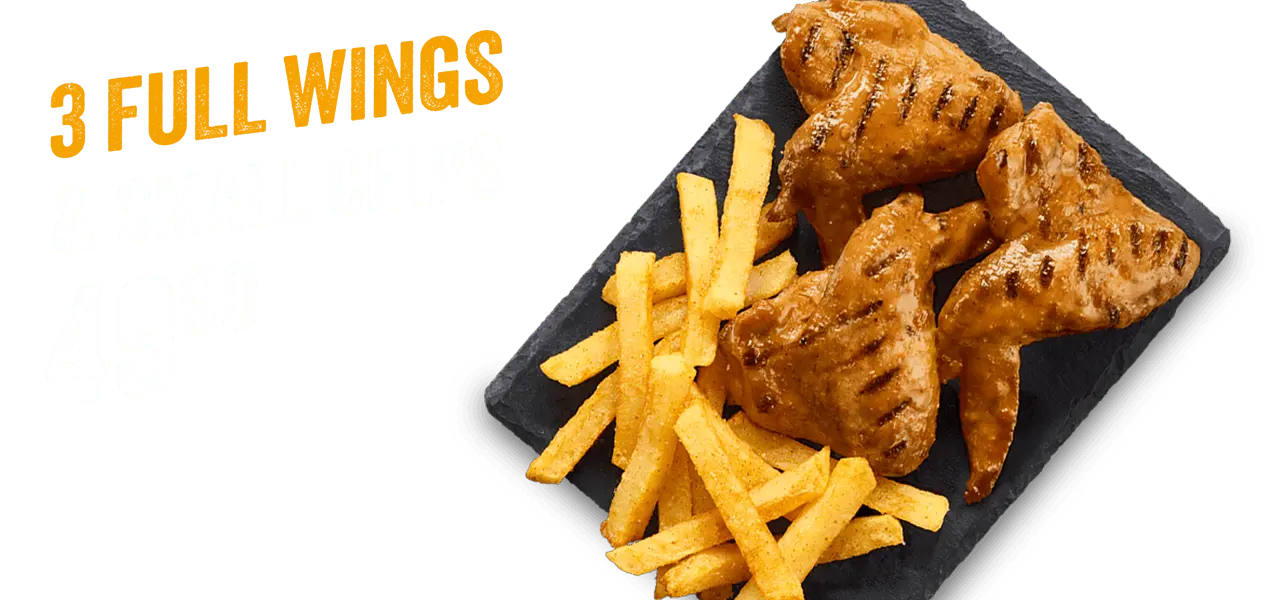 3 full chicken wings and small chips on a black slate against a purple background.